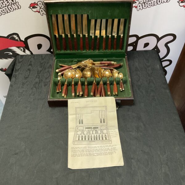 Vintage bronze cutlery set with wood handles in wooden case.