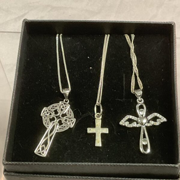 Silver Celtic cross pendant necklace with intricate knotwork design.
