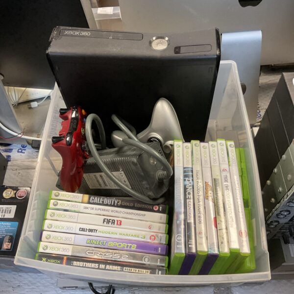 Microsoft Xbox 360 E console with games for retro gaming.