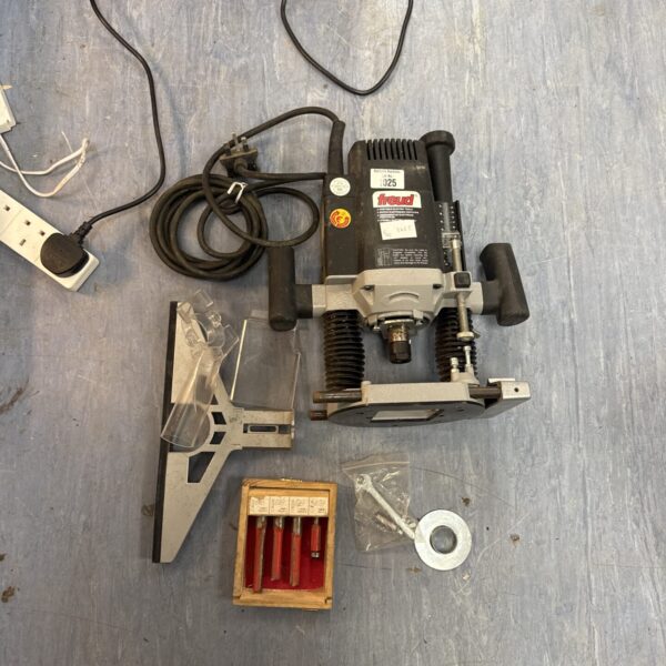 Freud corded router with included router bits for woodworking.