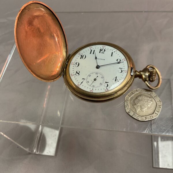 Vintage Waltham pocket watch with cracked glass cover.