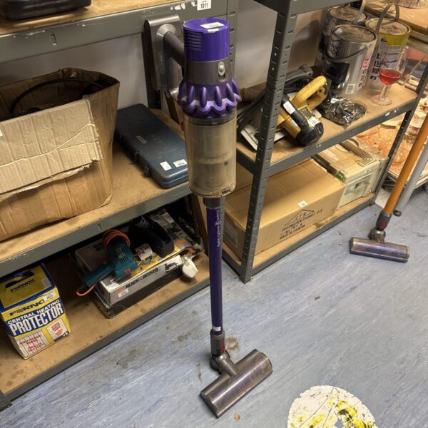Used Dyson V10 Animal cordless vacuum cleaner in a workshop setting.