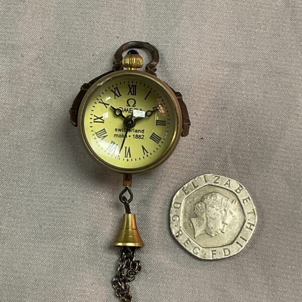 Front view of a vintage Omega ball pendant watch with a cream dial.
