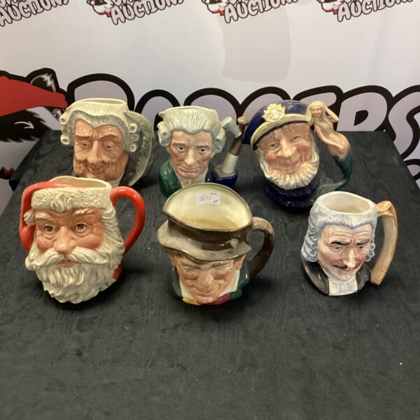 Six vintage Toby jugs, a collectible pottery collection.
