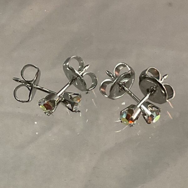 Close-up of 9ct white gold stud earrings with a sparkling stone.