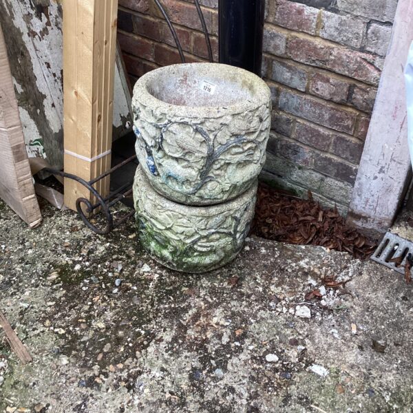 Two stone effect garden planters for outdoor use.