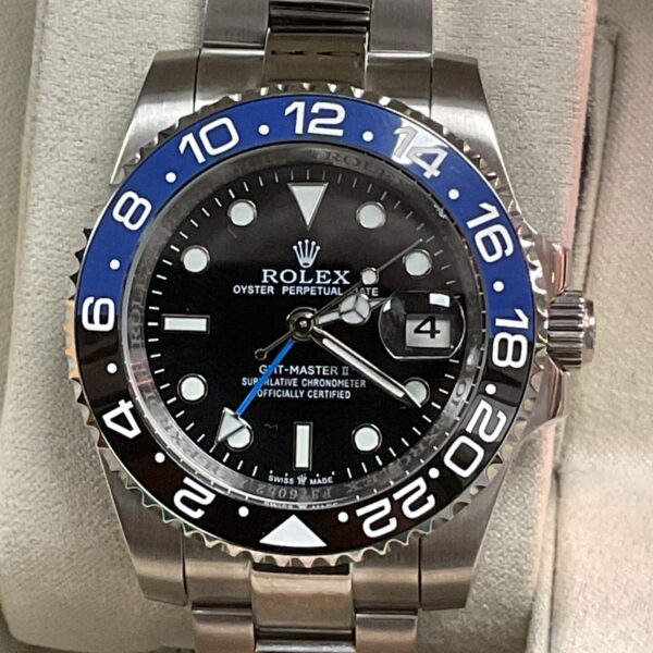 Front view of a stainless steel Rolex GMT Master II watch with blue and black bezel.