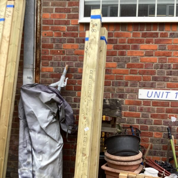 Three bundles of 8’6” timber stored outdoors, ready for projects.