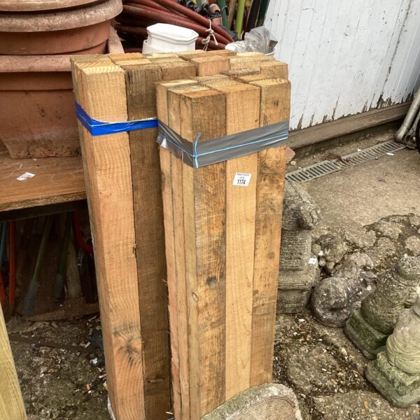 Three bundles of timber ready for construction or garden projects.