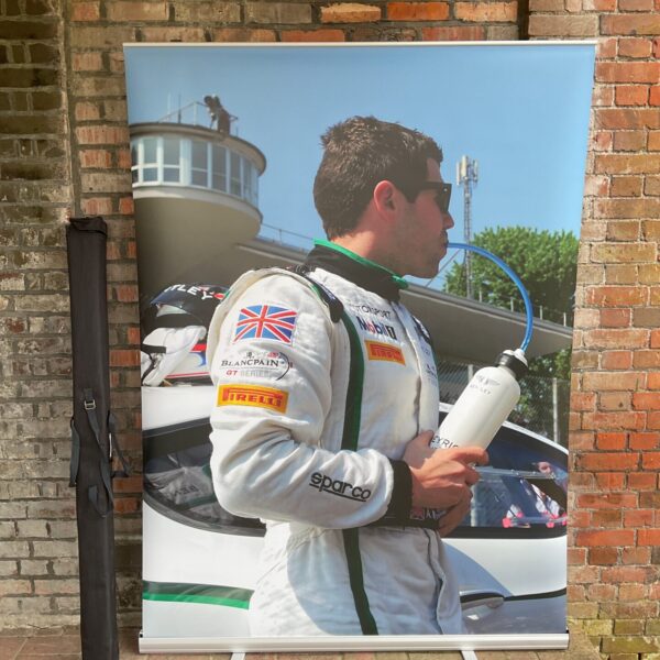 Bentley motorsport event display screen featuring a racing driver.