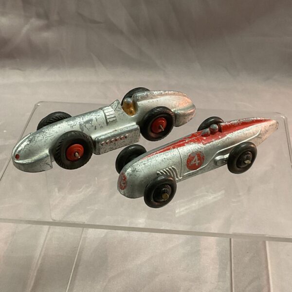 Vintage Dinky land speed cars, silver and red tinplate models.
