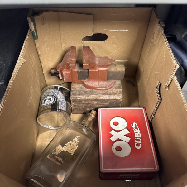 Vintage tool and collectible lot including tins, vice and bottle.