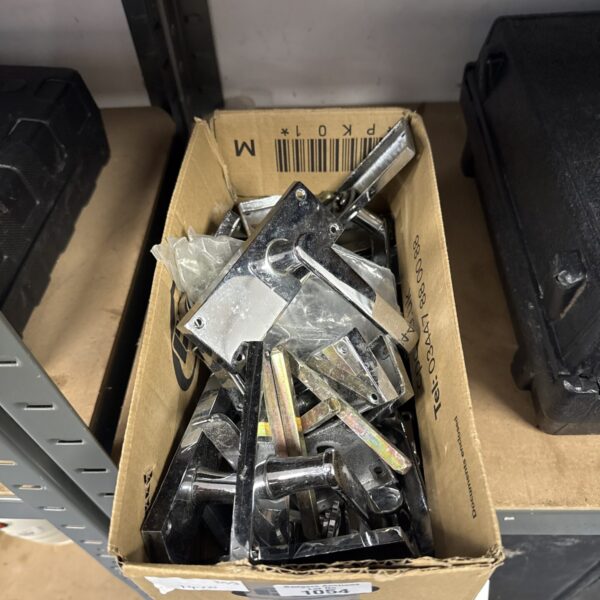 Chrome door handles in a box, vintage interior hardware.
