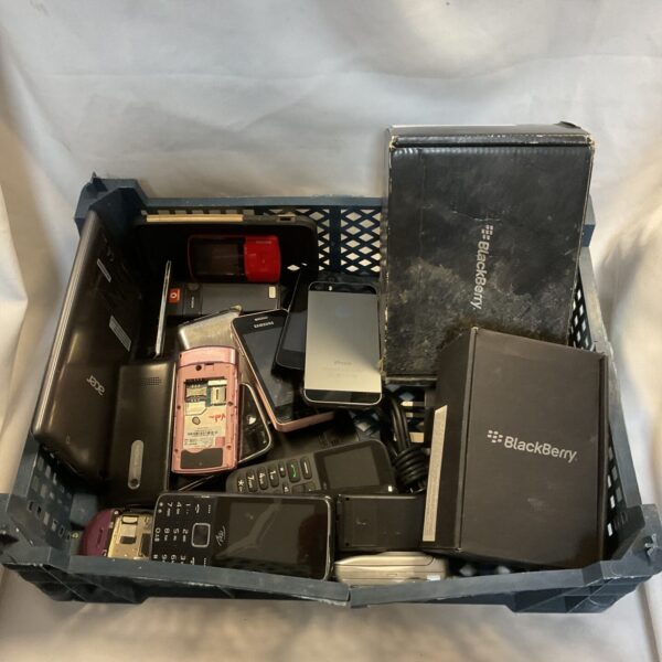 Tray of vintage mobile phones including Apple and Blackberry.