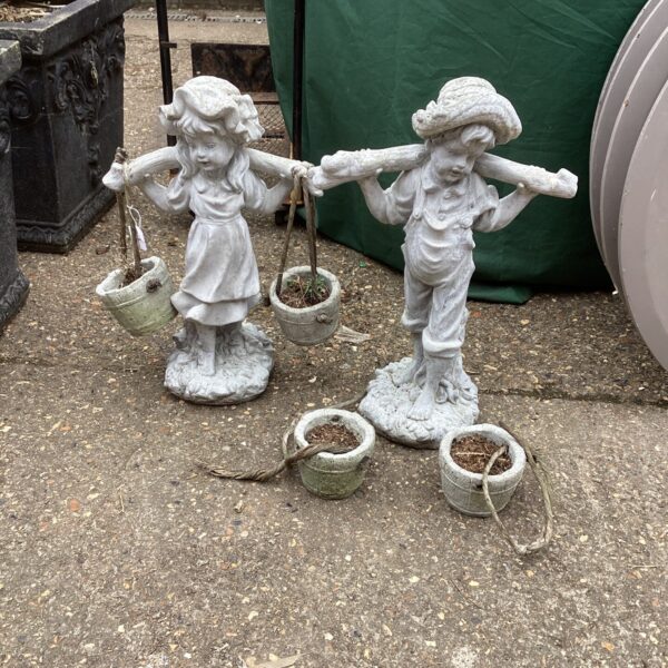 Vintage garden statues pair with stone effect finish.