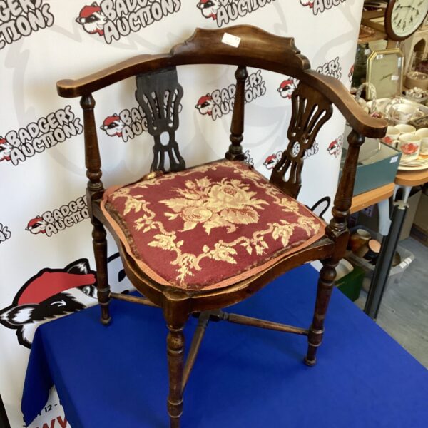 Floral upholstered Edwardian corner chair with turned legs.