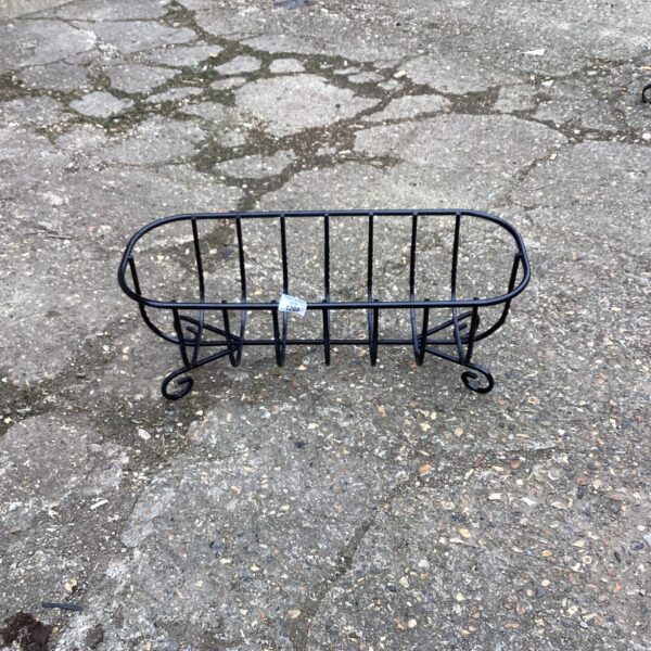 Vintage metal garden planter with looped handles, ideal for outdoor plants.