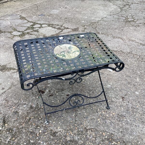 Decorative metal garden low table with wrought iron detailing.