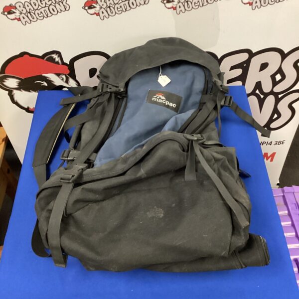 Front view of a used Macpac hiking rucksack, showing wear.