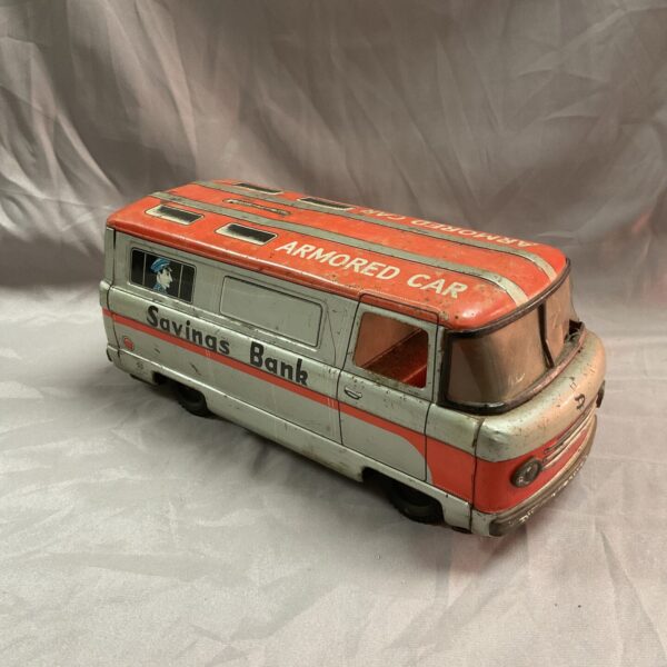 Vintage Japanese tinplate armored car money box, side view.