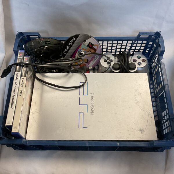Silver Sony PlayStation 2 console with controller and game.