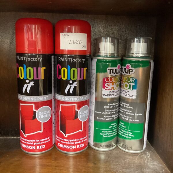 Red and green spray paint lot for crafting and DIY projects.