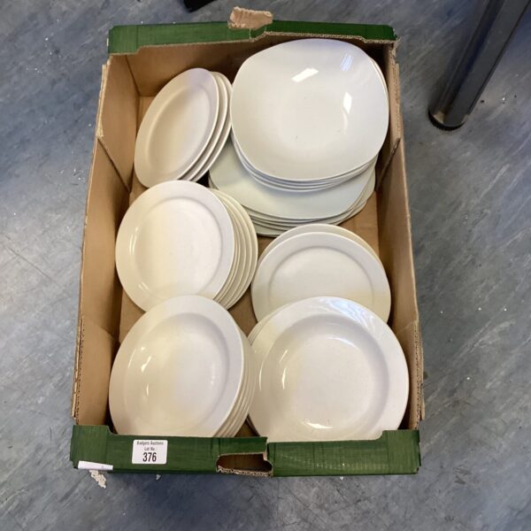White dinnerware set including plates and bowls on display.