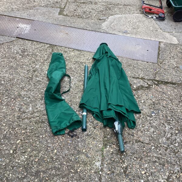 Large green garden parasol with metal pole.