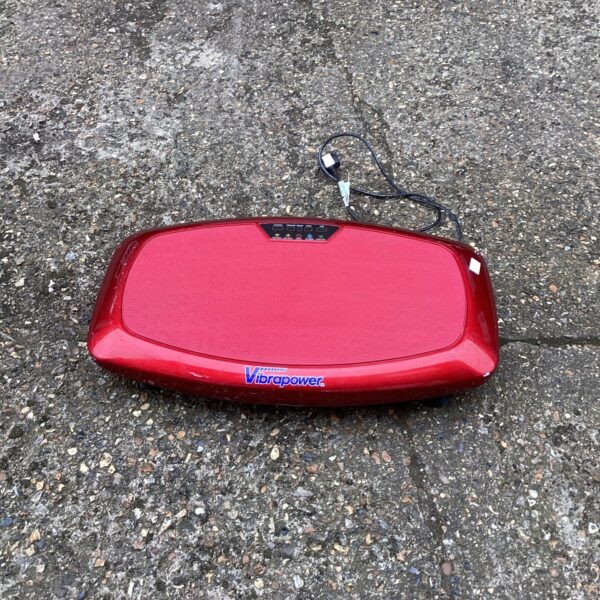 Side view of a red Vibrapower fitness board for home exercise.