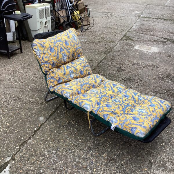 Floral patterned garden sun lounger with a folding frame.