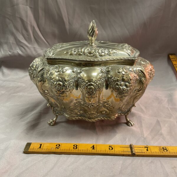 Antique silver caddy with floral embossing, hallmarked Chester 1904.