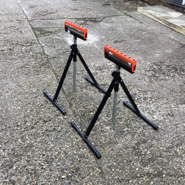 Pair of black metal folding trestles for work or events.