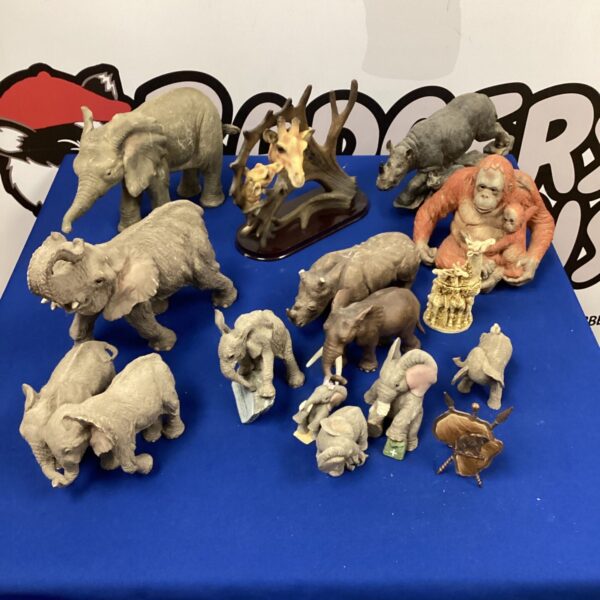 Detailed collection of African animal figurines including elephants and giraffes.
