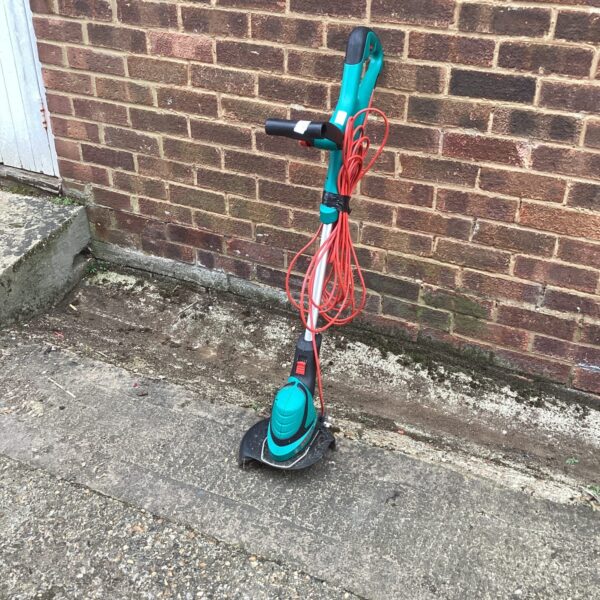 Bosch electric strimmer for garden maintenance and trimming grass edges.