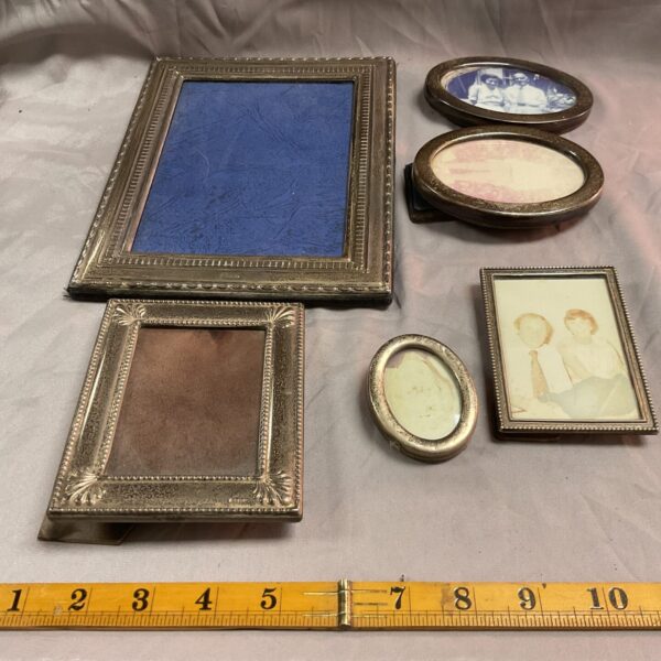 Lot of six antique silver photo frames, ornate designs.