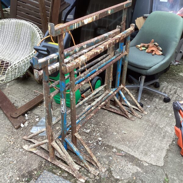 Pair of used metal builder's tressels for workshop support.