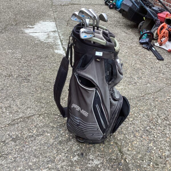 Black Ping golf bag with Mizuno irons, used sports equipment.
