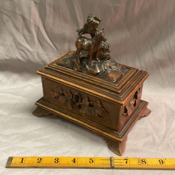Antique Black Forest jewellery box with carved hunting scene.