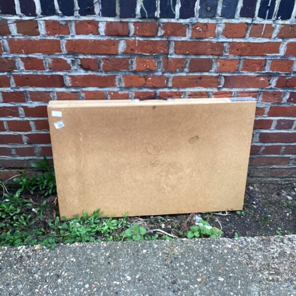 Vintage folding pasting table with a worn wooden surface.