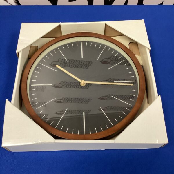 Vintage oak wall clock with a classic analog face.