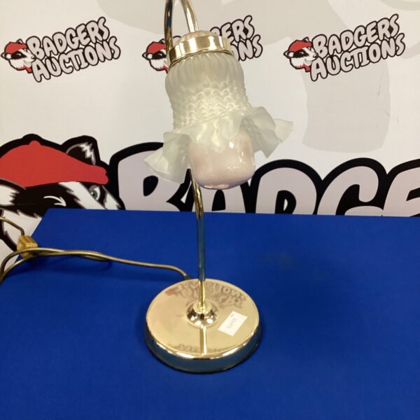 Vintage brass tulip table lamp with a curved shade.