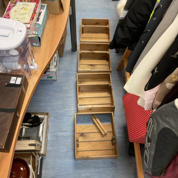 Lot of four rustic wooden storage crates for display.