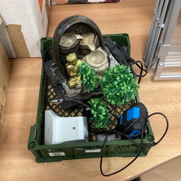 Tray of mixed indoor water feature components with pump and foliage.