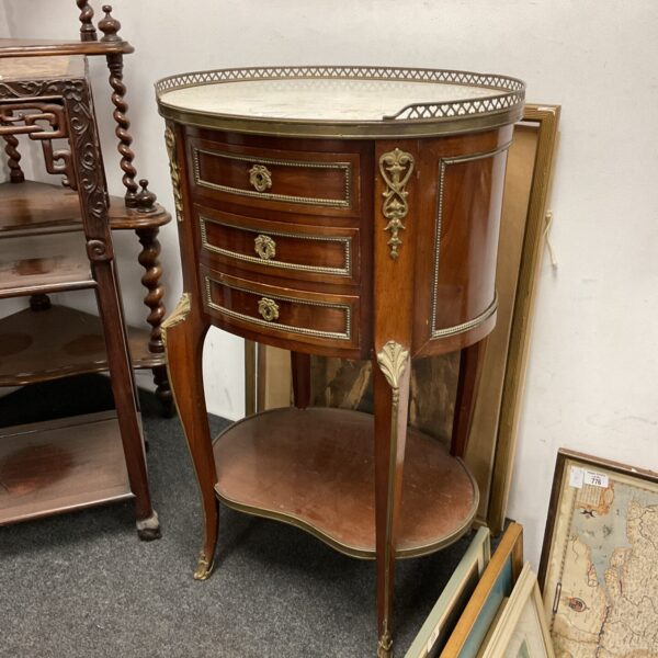 Antique French mahogany table with marble top and brass gallery.