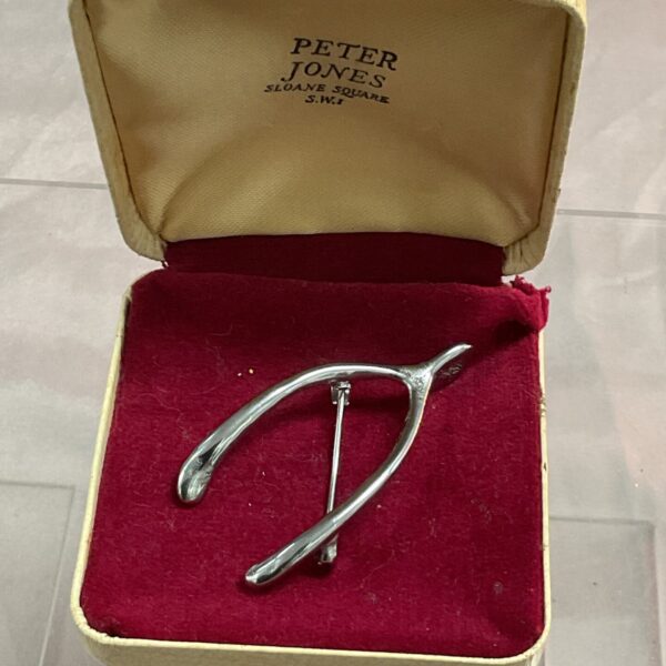 Vintage whitemetal wishbone brooch, a collectible jewellery piece.