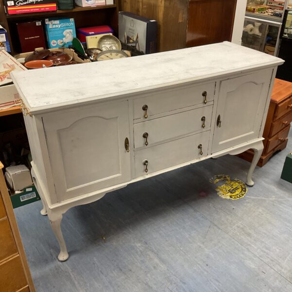 Shabby chic sideboard cabinet with brass handles and distressed paint.
