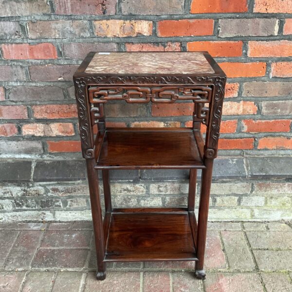 Antique Chinese hardwood occasional table with marble top and carved details.