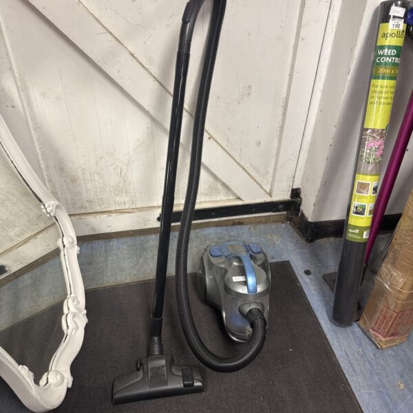 Compact Tesco cylinder vacuum cleaner with hose attached.