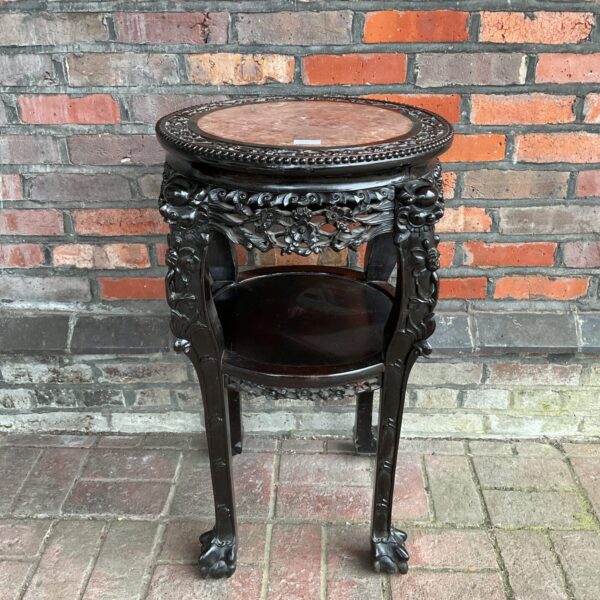 Intricately carved Chinese hardwood table with marble top.