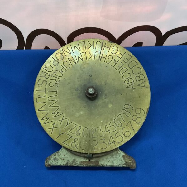 Vintage brass Caesar cipher disc for encryption and decryption.